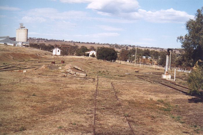 
The view from the turntable back up the yard.  In the distance are the
goods shed and station building.  In the centre was the location of the
engine-shed. The water-column is still present on the right although
the tank has gone.
