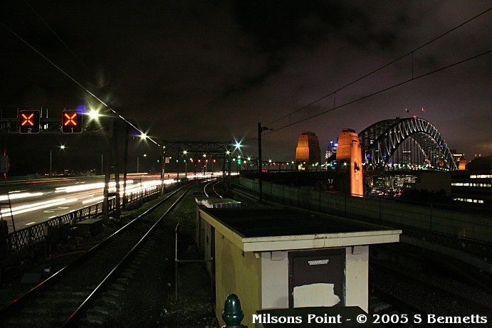 Milsons Point station after dark. Taken from the Harbour Bridge end of  the platforms looking at Harbour Bridge and approaches.