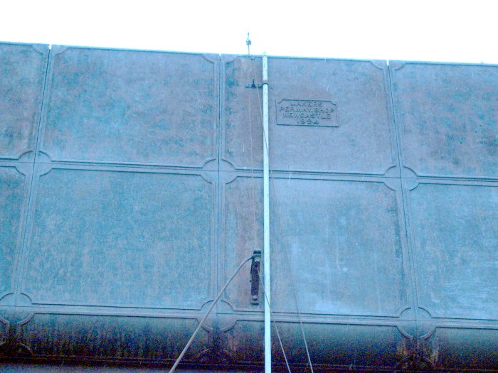 A close-up of the tank, showing the maker's name.
