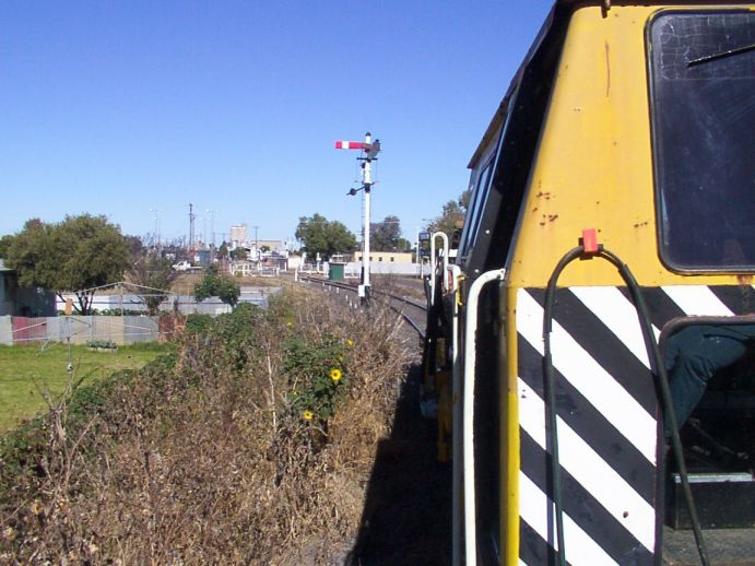 
The view from a track maintenance vehicle, approaching Moree from the
north.  The semaphore is the Moree Up Home signal.
