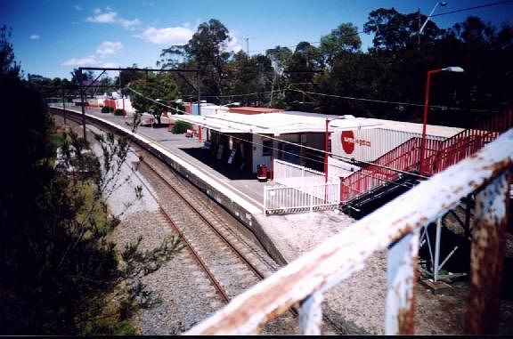 
The view looking south along Mount Colah station as a northbound freight
passes through.
