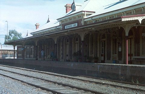 
The impressive rail-side view of Mudgee station.  The sign above the
awning shows the station's opening date - 1884.
The small building in the far left hand edge is the preserved remains of
the foot warmer heating ovens from the days of the Mudgee Mail.
