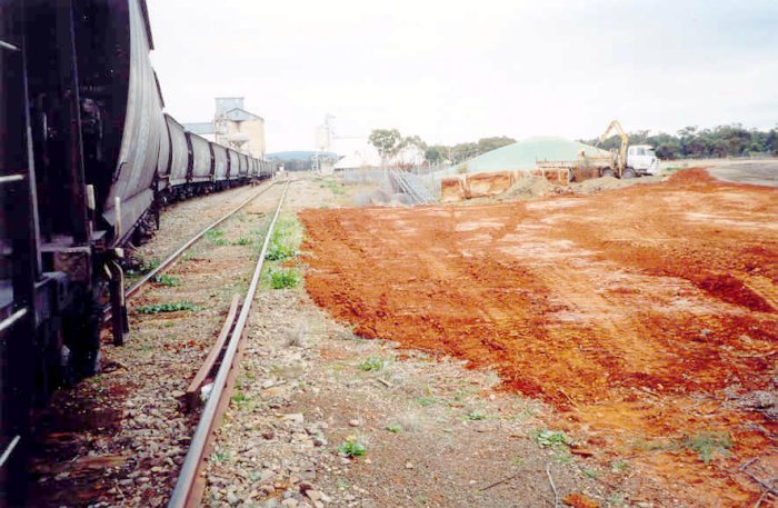 A view looking towards the dead end, as a train shunts the grain silo.  The goods siding is on the up side.