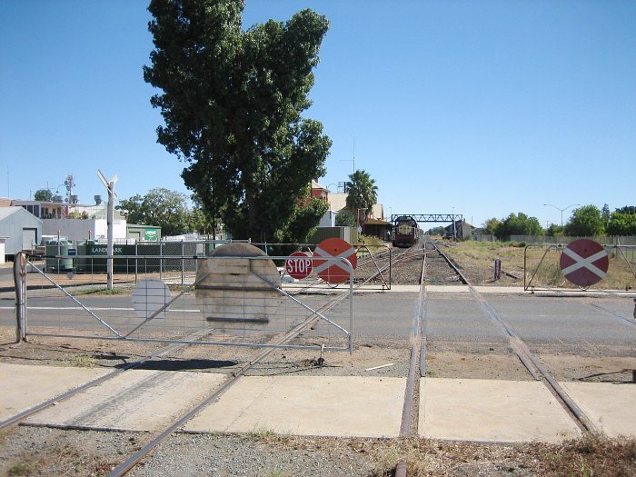 The level crossing just before the station. The gates must be manually opened and closed by the crew of passing trains. Locomotive 4908 stands at the station with a tour train.