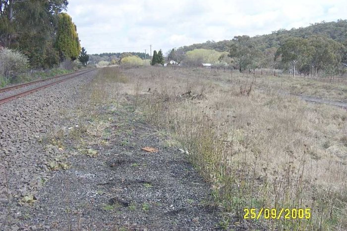 The view looking along the location of the two storage sidings. The station was located on the left side of the main line. Behind the fence posts on the right is the formation of the one-time branch to the Ivanhoe Colliery. This was also used during the construction of the dam which now occupies that site.