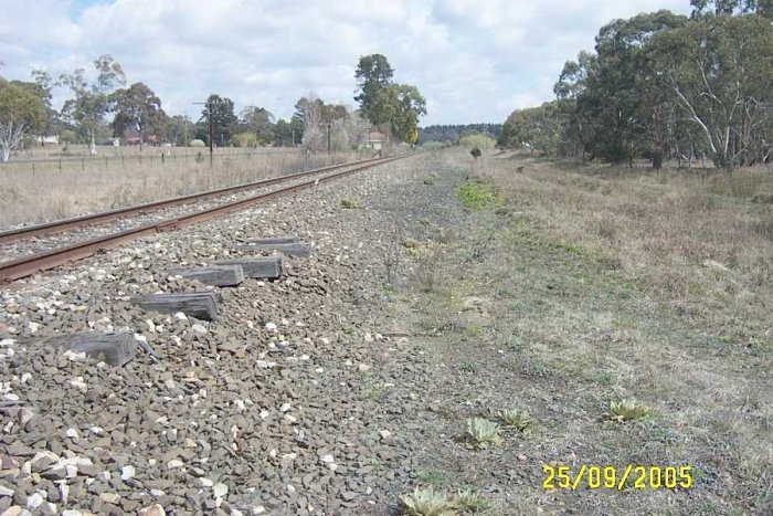 The view looking west towards the site. The longer sleepers in the foreground are where a pair of siding left the main line and extended into the distance.