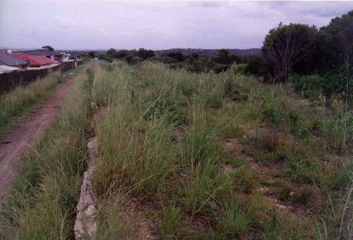 
The view looking down the remains of the platform.  The formation of 
the Main Line is on the left.
