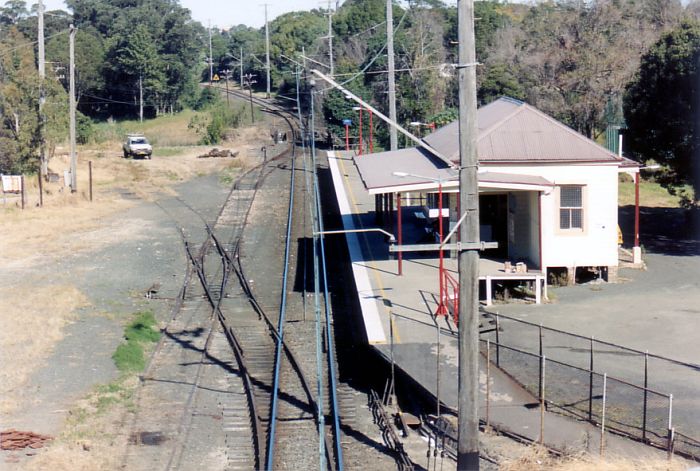 
Rydalmere Station looking towards Camellia from the Victoria
Road overbridge. This station building and platform has since been
demolished and replaced in the same position but on the opposite side of the
main line where the short goods sidings are seen in the picture. The Up
Camellia Landmark signal is visible in the distance.
