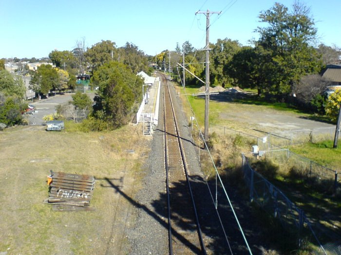 A view of the new Rydalmere station taken from the Victoria road overpass looking towards Camellia. In the fenced off area on the right hand side you can see the remnants of the old station carpark and on the left hand side a stack of wooden sleepers, most likely from the former goods siding that once existed where the new station now sits.