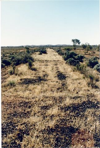 The view looking from the former bridge along the formation towards Broken Hill.