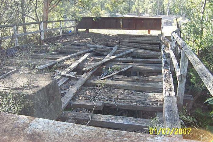 The deck of Tin Bridge, it looks like a vehicle has nearly gone through it at the far end.