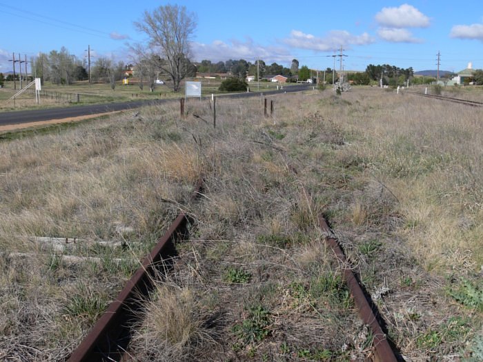 The short branch curves off to the left and passes along the fence in the left distance. The main line is visible on the right.