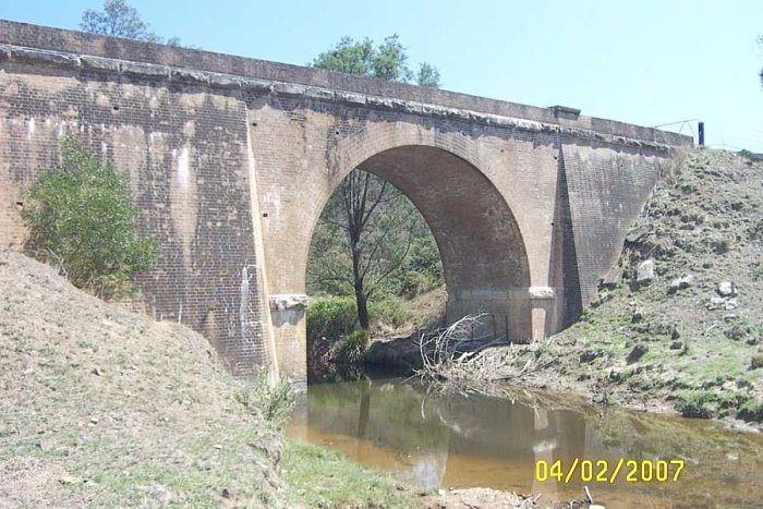 The Third bridge crossing of Solitary Creek; a single arch bridge.