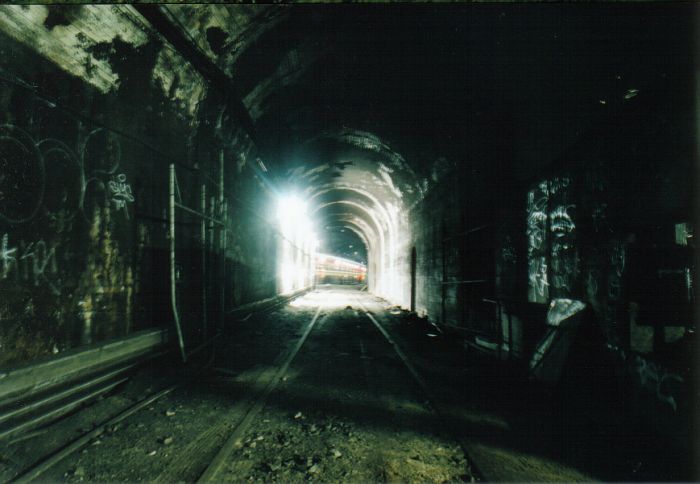 
The view from one of the terminating road tunnels, looking back at platform
2 (City Outer tunnel), with a train passing in the distance.
