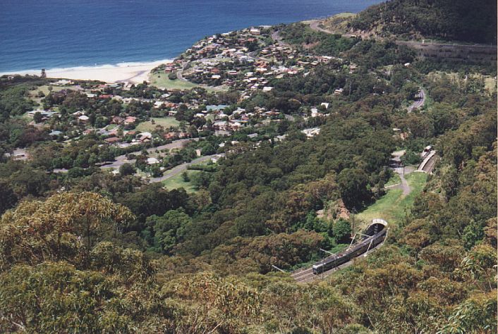 
Looking down on Stanwell Park.  The station is at the far right, just beyond
the tunnel. A "V Set" is heading up the hill towards Sydney.
