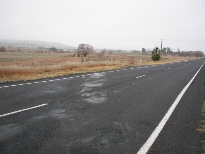 View south showing line crossing New England Highway.