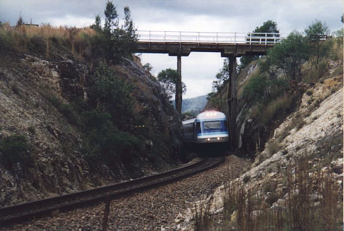 
Southbound XPT passes under a high road bridge just to the south
of Stroud Road.
