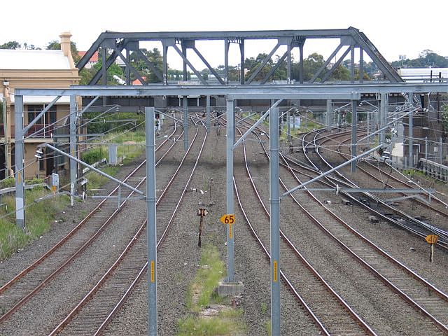 
The busy track-work to the south of the station.  The main Illawarra lines
extend to the middle distance, with the tracks on the right leading to
the Bankstown line and the Meeks Road servicing centre.  The bridge over
the top carries the Botany Goods Line.
