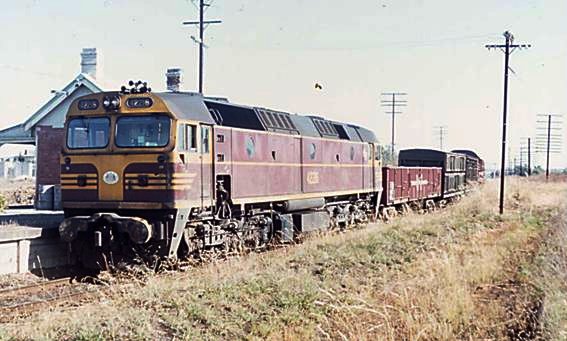 A 422 class locomotove heads a freight service through the station.