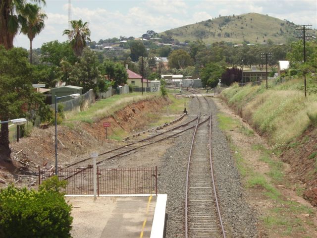 The view from the footbridge looking in the Up direction (towards West Tamworth). The points that serve the dock seem to be available for use . The slight kink in the mainline gives a clue that the  track that was the mainline has been slewed to connect with former Platform Road. The mainline in the station precinct has been removed to leave the single track.