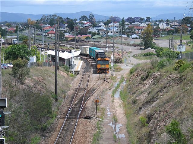 
The view looking south from the northern end of the yard. NR83 waits opposite
the station for the afternoon XPT to cross over before it can head north on
to the single-track line.
