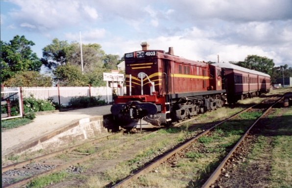 4803 stands at the head of a tourist train at the station.