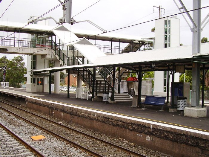 Another view of the island platform at Thirroul showing the canopy and footbridge connecting this platform to the up platform and the street exits.  The towers are for lifts being installed (September 2005) at this station.
