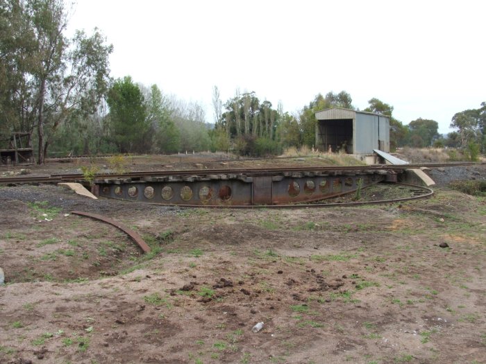The Turntable which is located at the western end of the yard attached was taken last year looking south. The shed is on the locomotive siding, which can be seen, it is a recent addition (disused) for storing cement for the Snowy scheme. The main line can be seen in the background.