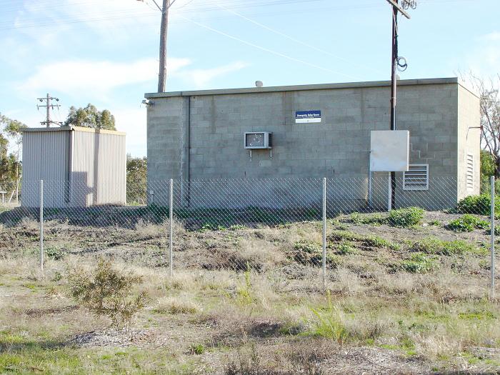 The road-side view of the modern concrete signal box.