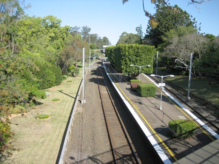 Wahroonga station looking south from a pedestrian overbridge. The well kept gardens are a major feature of the station.