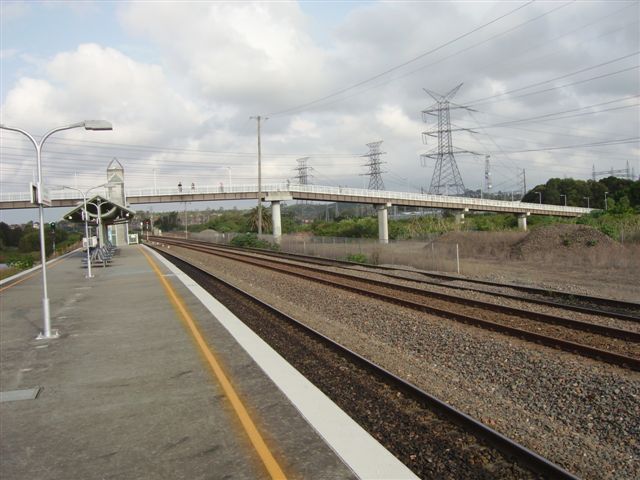 Looking east towards Hanbury Junction. The ramp, straddling the Down Main and the Coal Roads, linking the station to the pathway and road link to Newcastle University.