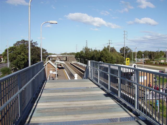 Looking east, this view of the landing on the footbridge shows the part of the footprint of the former wooden station building that was part of the structure.