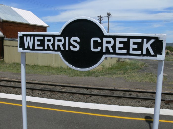 A traditional station name-board.