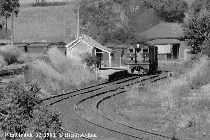 
An up wheat train passing through Wimbledon station in December 1981. The Loop
and Goods Siding are at right, with the railway residence visible in
background.
