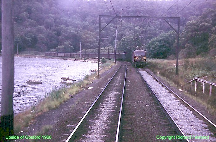 A north-bound goods train headed by a 46-class loco is passing along Mullet Creek before approaching Wondabyne.