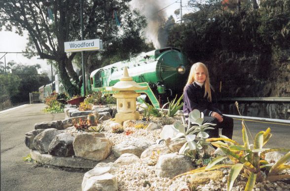 
Restored steam locomotive 3801 races through Woodford station.

