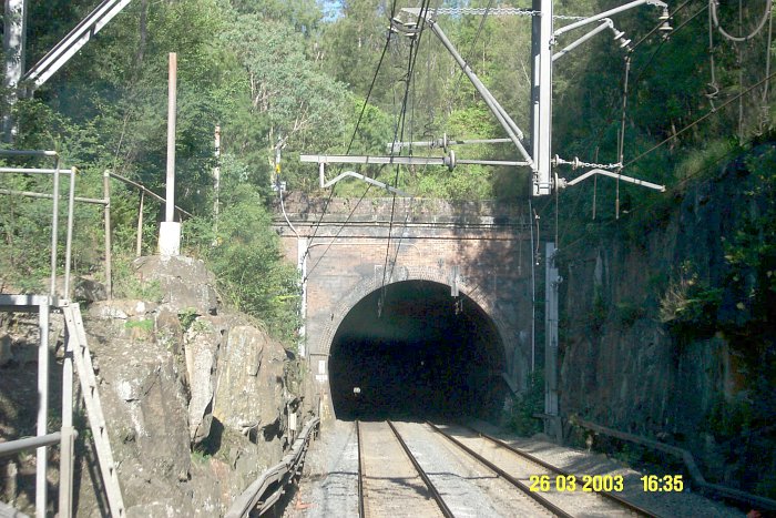 The view looking through Woy Woy tunnel from the Sydney end. The tunnel is straight, however there is an average grade of 1 in 150 downhill to the Woy Woy end.