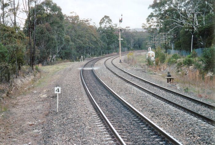 
The view looking south from the down end of the station.  The disconnected
lever frame and semaphore signals are relics of an earlier era.  The
"4" sign indicates the stopping location for a 4-car railset.
